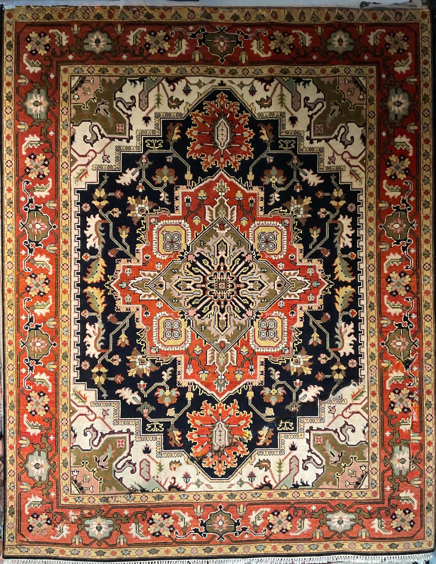 A striking Heriz design rug features a bold black and rust | 1690