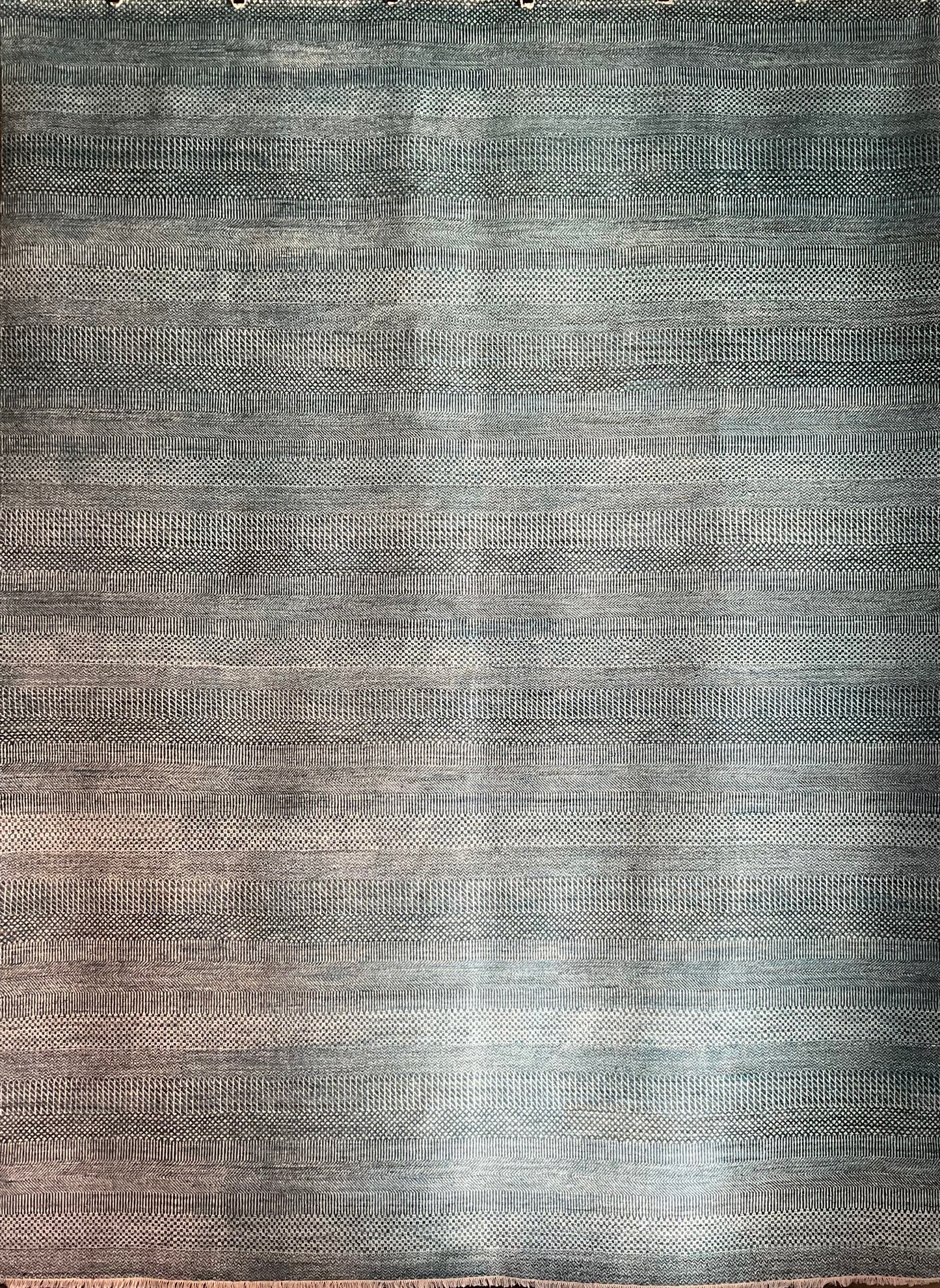A modern wool and silk rug brings together soft tones of blue, grey | NU-4617