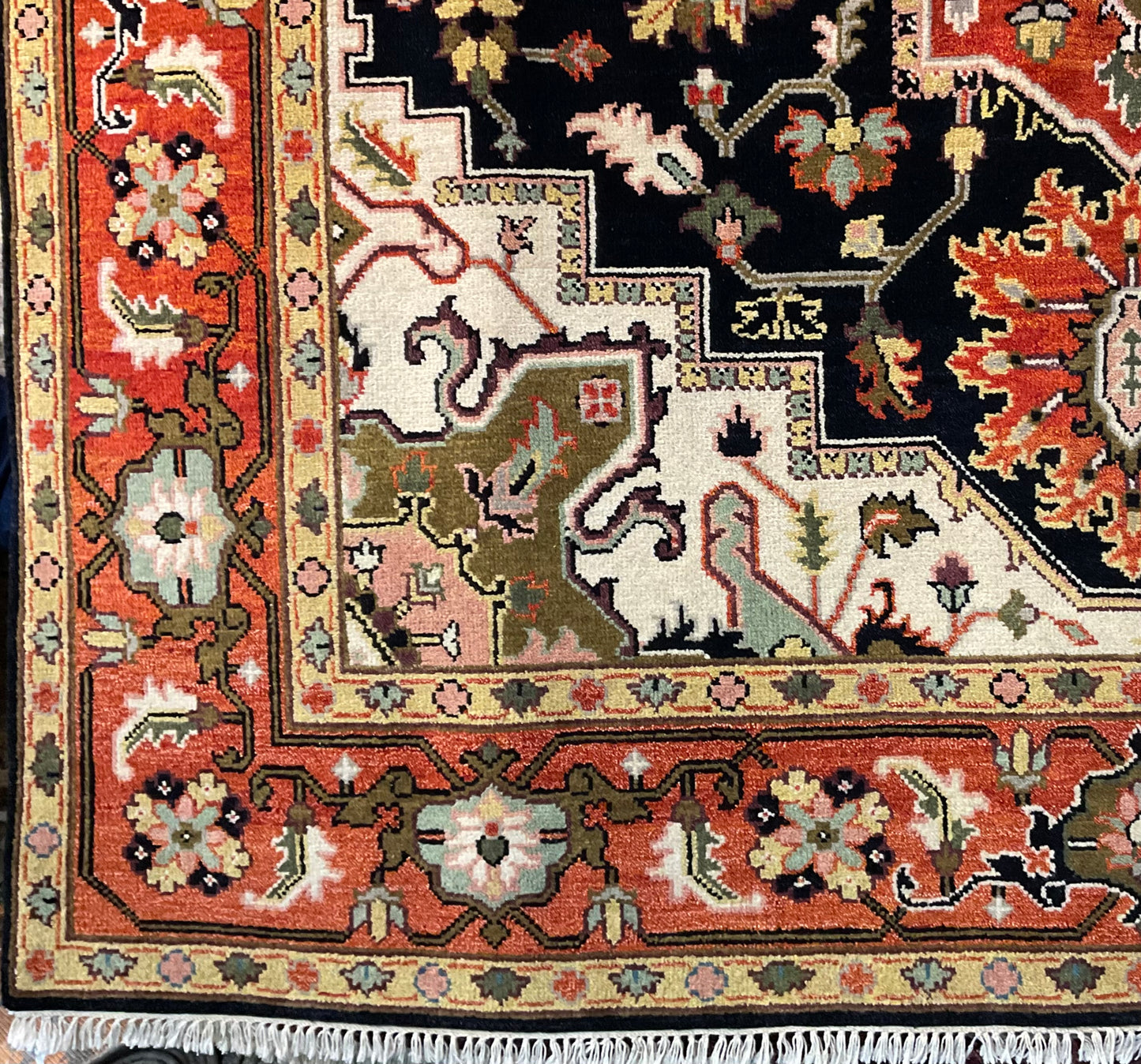 A striking Heriz design rug features a bold black and rust | 1690