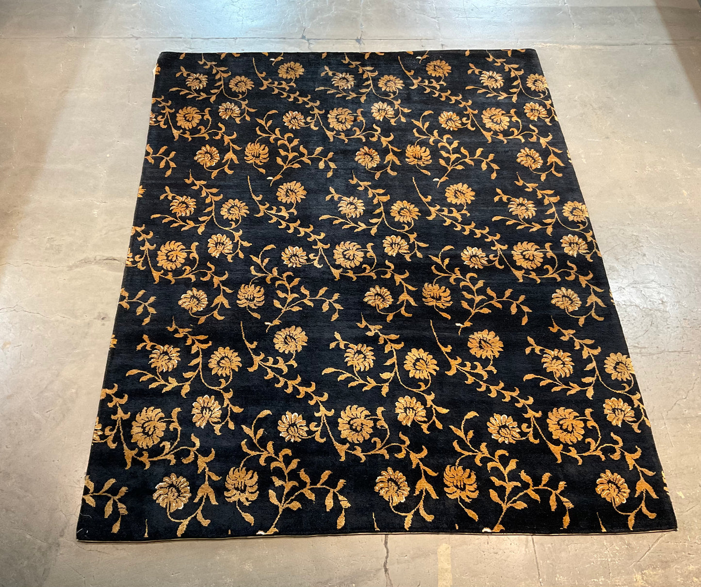 Floral design rug in a rich black and gold palette | NU-2557