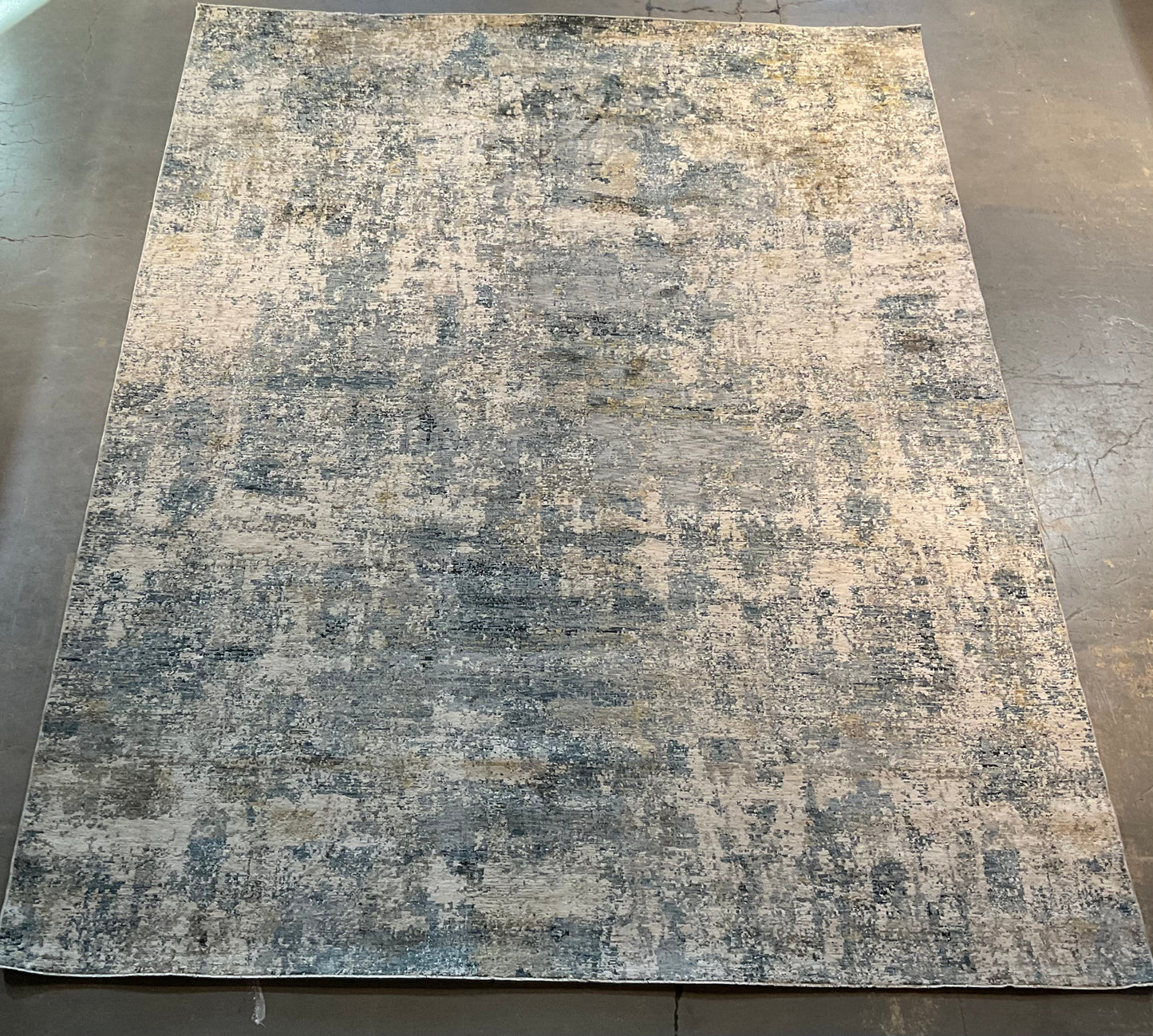 Modern rug features layered shades of blue, grey, soft gold | NU-7789