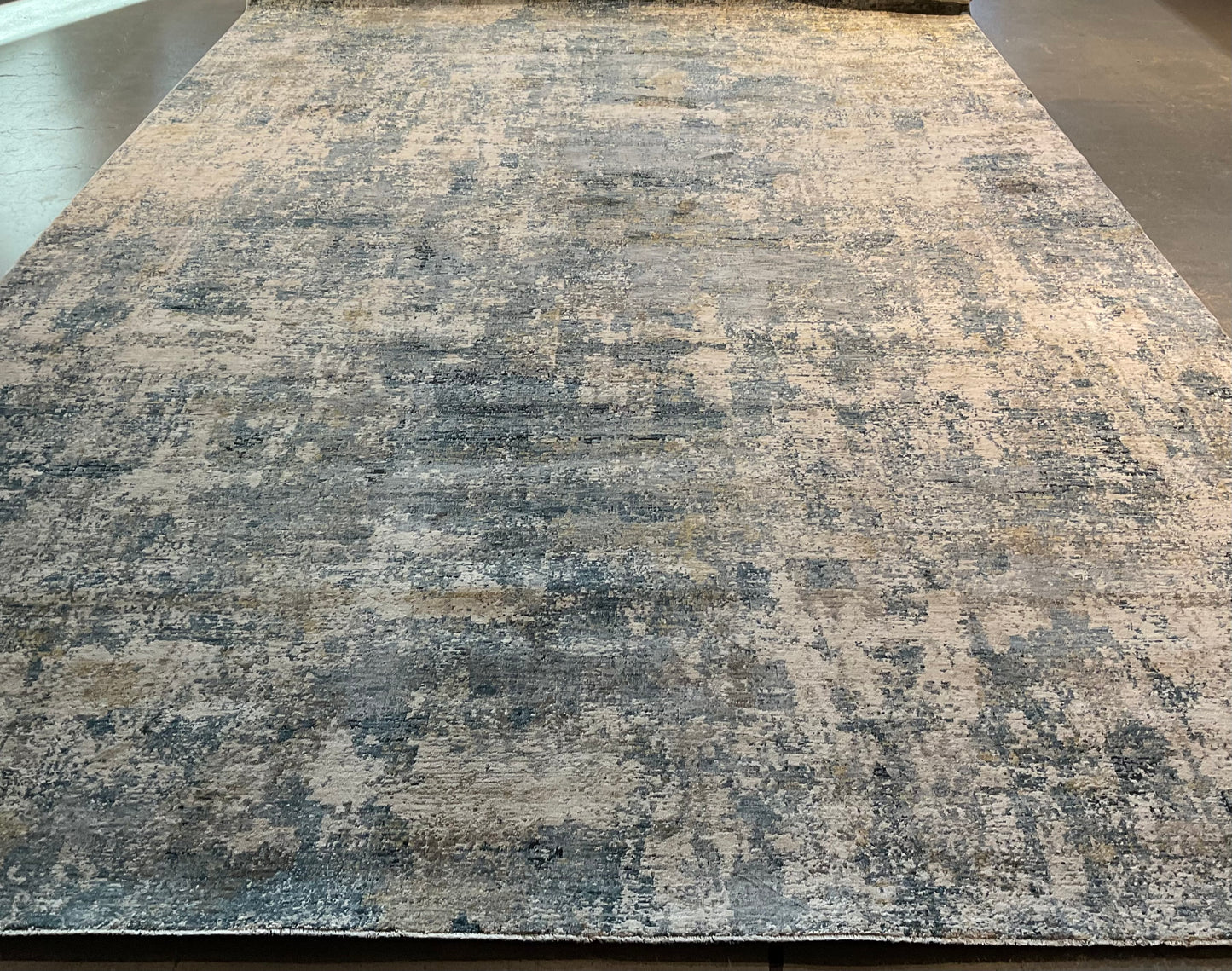 Modern rug features layered shades of blue, grey, soft gold | NU-7789