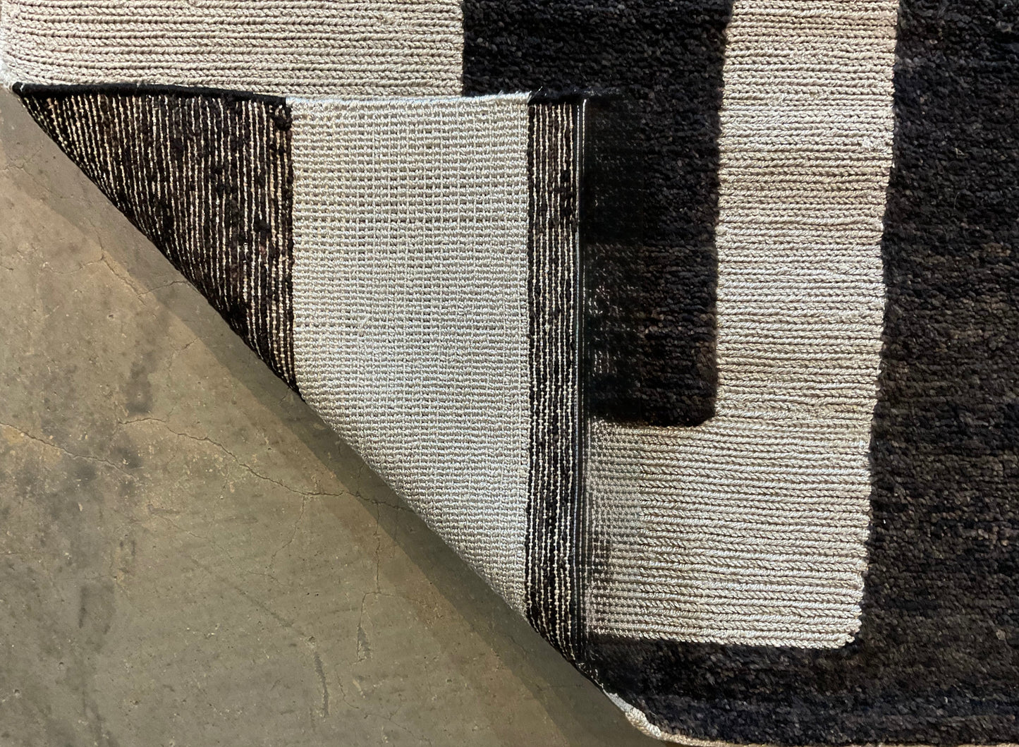 Ultra-modern rug features a deep black and charcoal | NU-2585