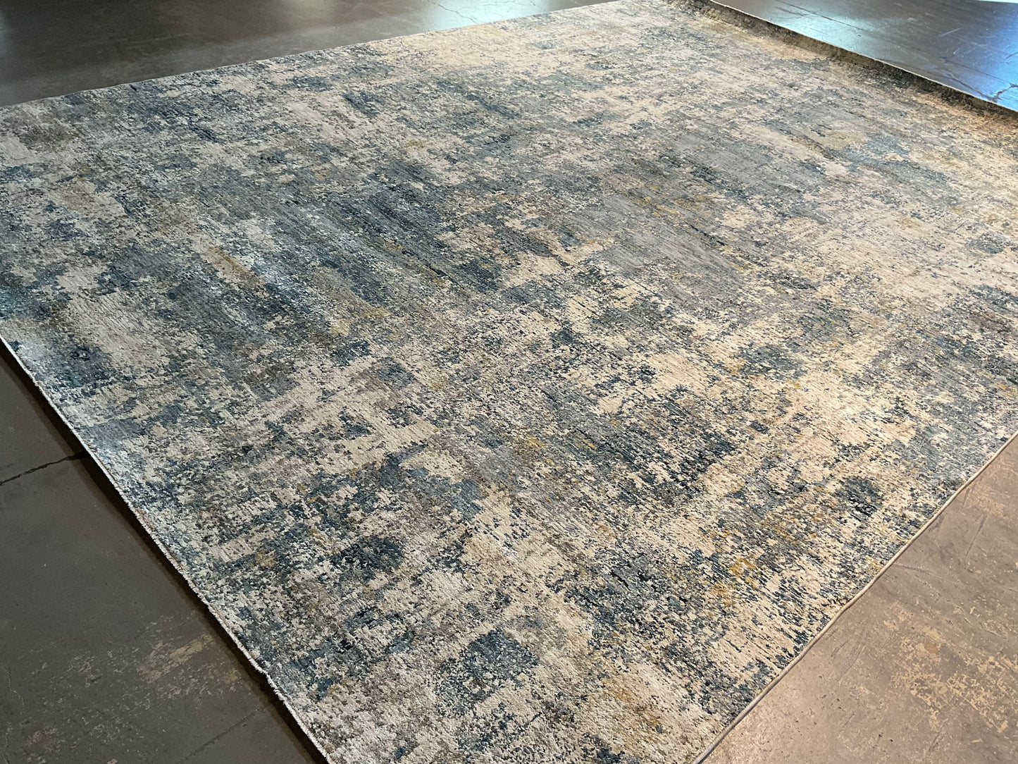 Modern rug features layered shades of blue, grey, soft gold | NU-7789