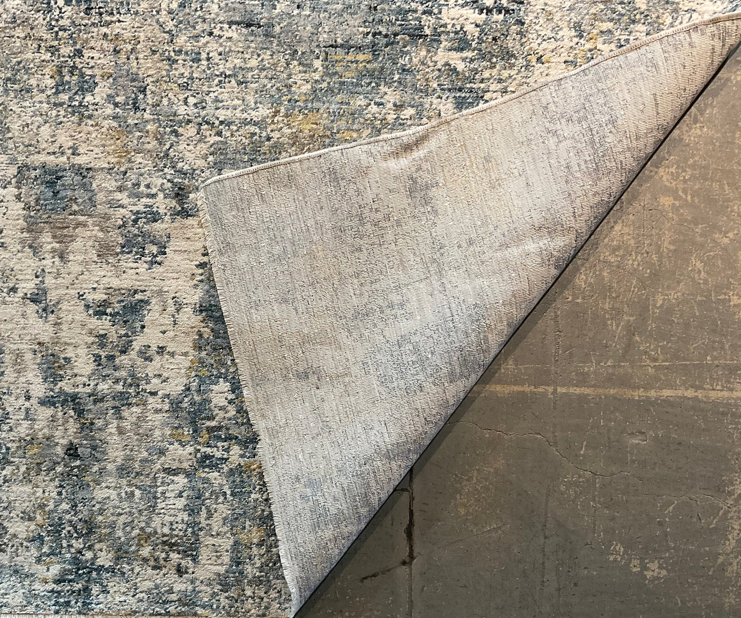 Modern rug features layered shades of blue, grey, soft gold | NU-7789