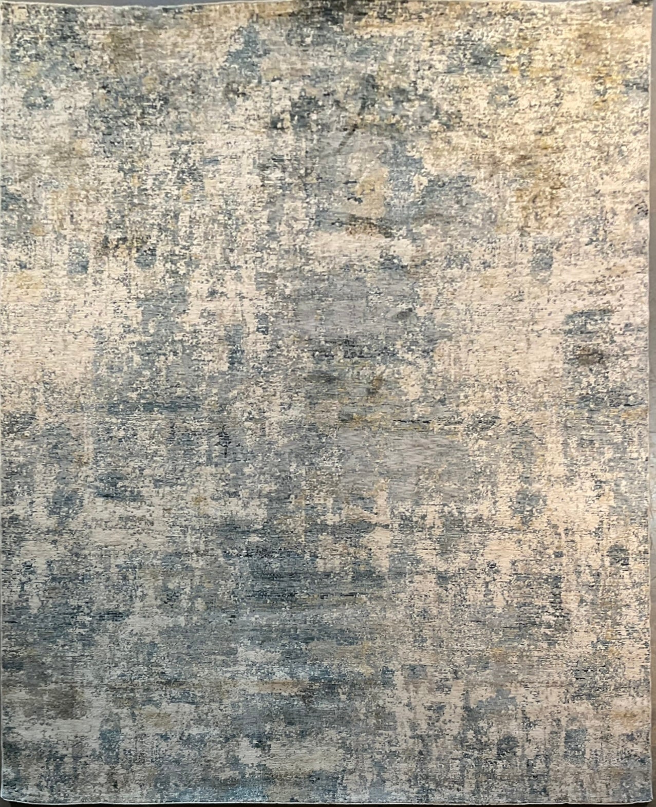 Modern rug features layered shades of blue, grey, soft gold | NU-7789