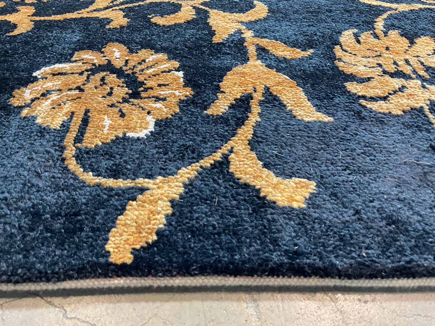 Floral design rug in a rich black and gold palette | NU-2557