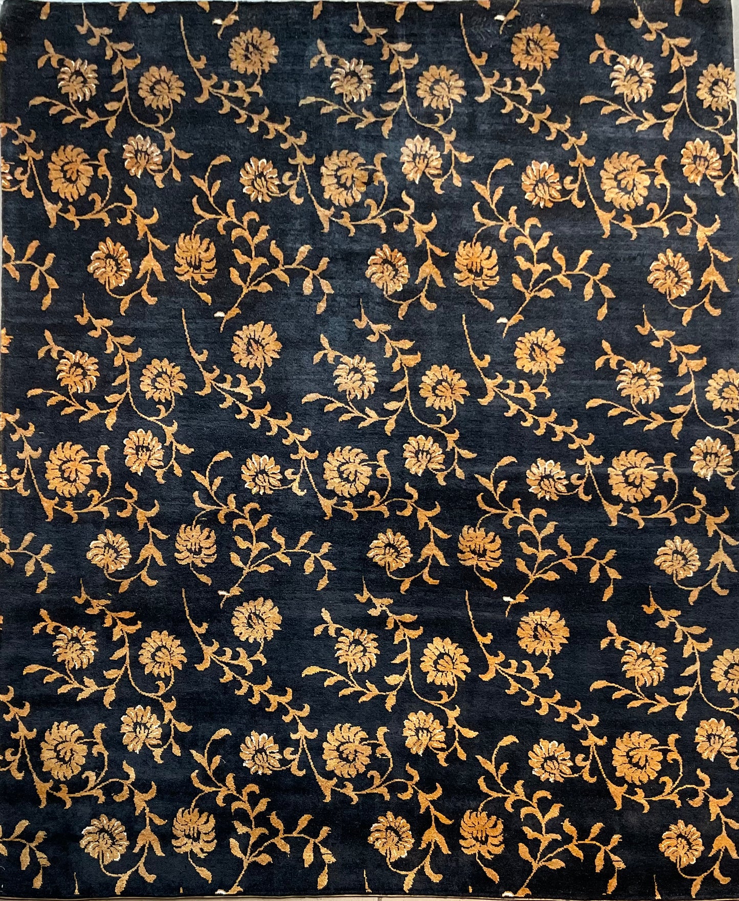 Floral design rug in a rich black and gold palette | NU-2557